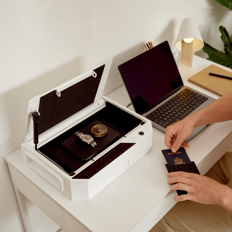 Case Safe on Desk with Hand Holding Passport Holder